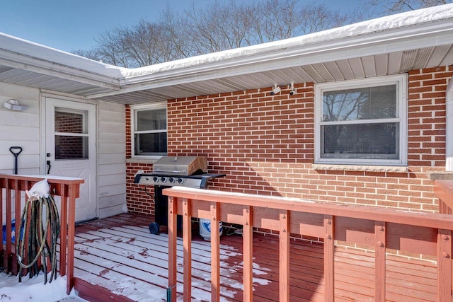 snow covered deck featuring grilling area