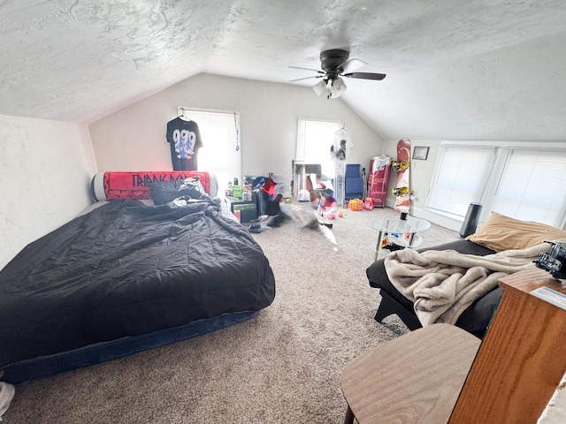 carpeted bedroom with a textured ceiling, vaulted ceiling, and a ceiling fan