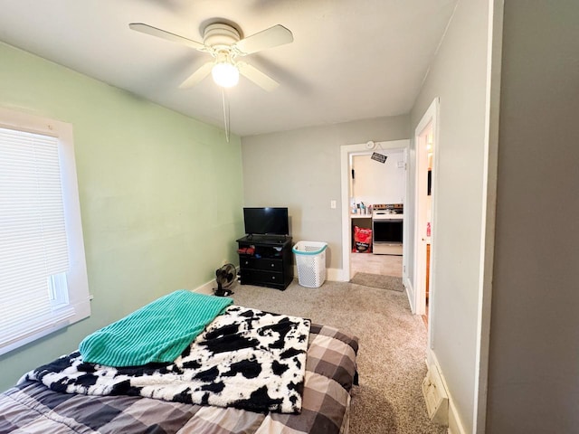 carpeted bedroom featuring baseboards and a ceiling fan