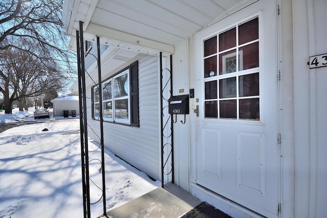 view of snow covered property entrance