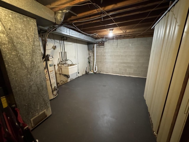 basement featuring sink and gas water heater