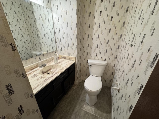 bathroom with tile patterned flooring, vanity, and toilet