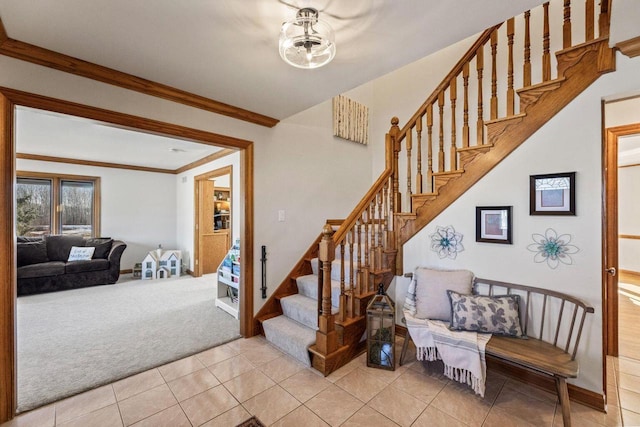 stairway with ornamental molding and carpet floors