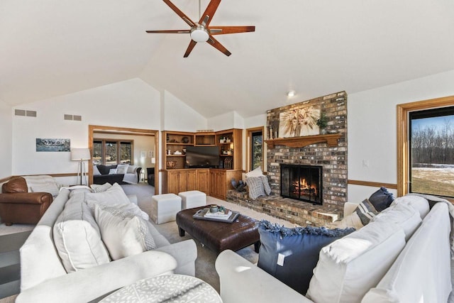 living room featuring vaulted ceiling, a brick fireplace, and ceiling fan