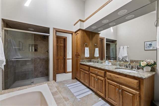 bathroom featuring tile patterned floors, vanity, and a shower with door