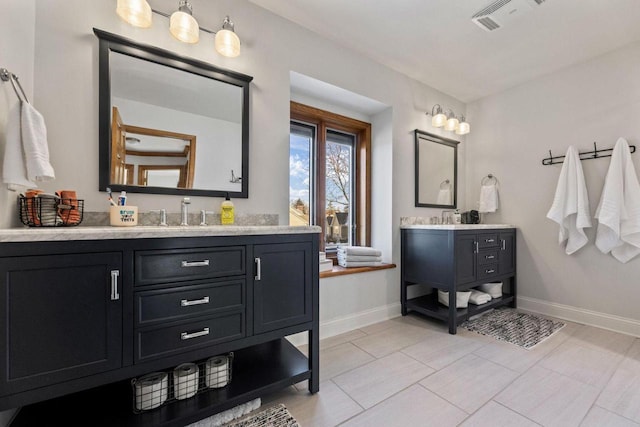 bathroom with tile patterned floors and vanity