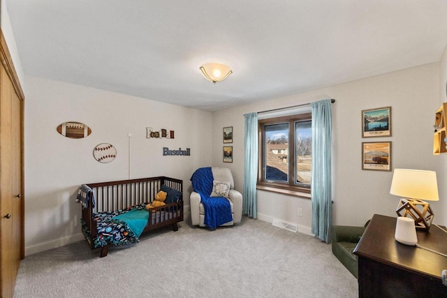 carpeted bedroom with a nursery area