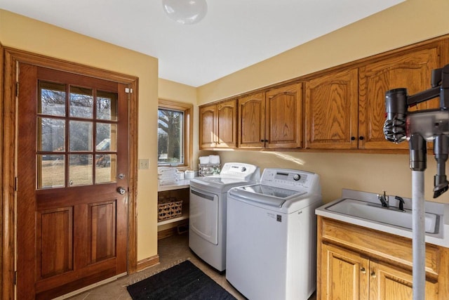 laundry room with sink, cabinets, independent washer and dryer, and tile patterned floors