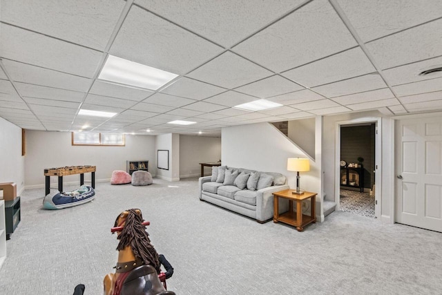 carpeted living room with a paneled ceiling