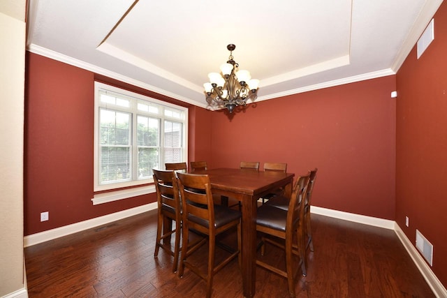 dining room with a raised ceiling, visible vents, dark wood finished floors, and baseboards