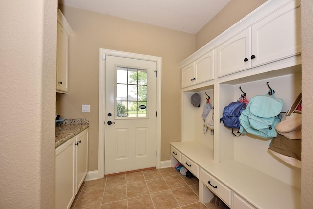 mudroom featuring light tile patterned floors and baseboards