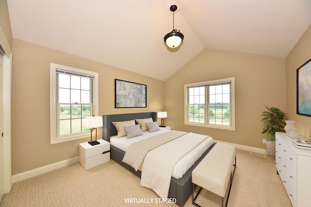 bedroom with light carpet, vaulted ceiling, and baseboards