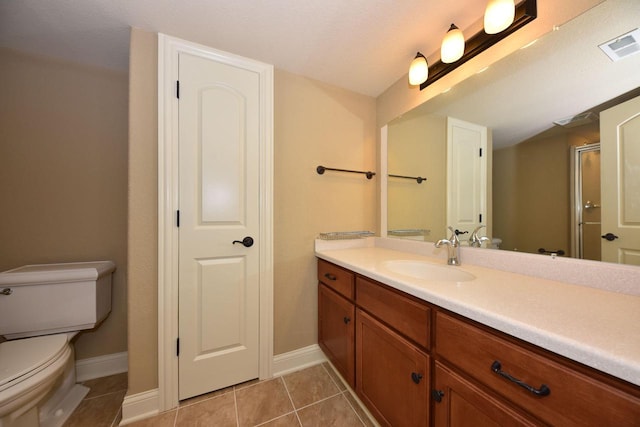 full bath with toilet, vanity, baseboards, visible vents, and tile patterned floors