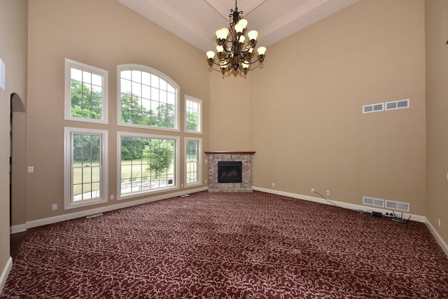 unfurnished living room with carpet, visible vents, baseboards, and a glass covered fireplace