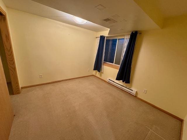 carpeted spare room with baseboard heating