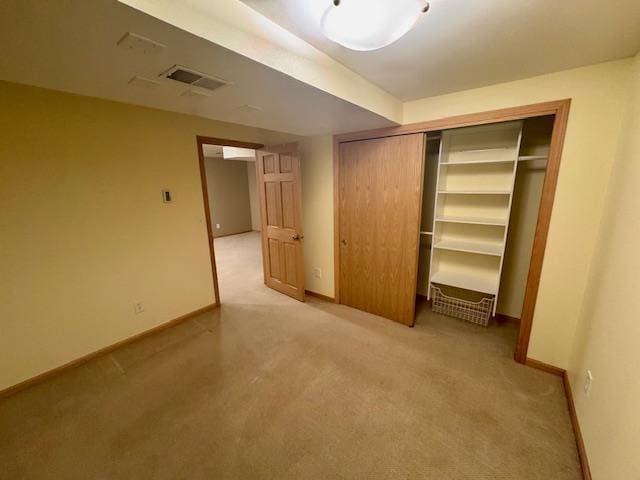 interior space with light colored carpet and a closet