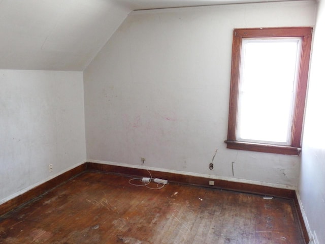 bonus room with vaulted ceiling and dark hardwood / wood-style floors