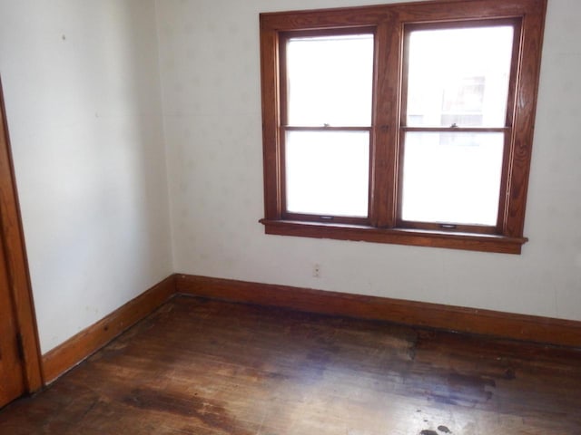 unfurnished room with dark wood-type flooring