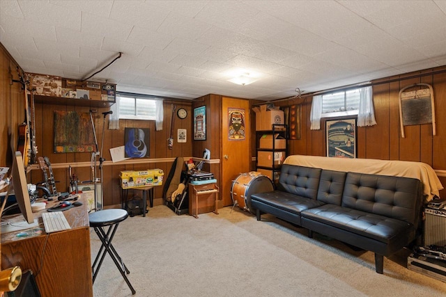 carpeted living room with wooden walls