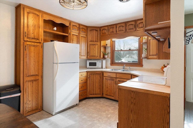 kitchen featuring sink and white appliances