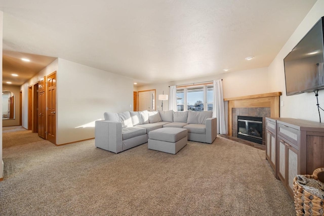 living room featuring a tile fireplace and light colored carpet