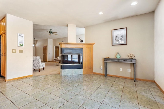 unfurnished living room featuring ceiling fan, light tile patterned floors, and a multi sided fireplace