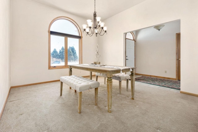 dining room featuring light colored carpet and a notable chandelier