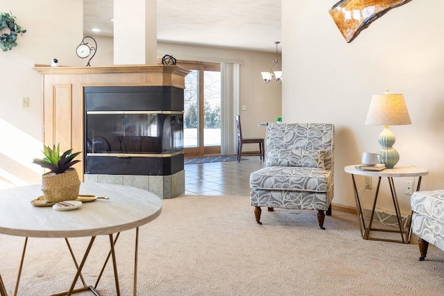 sitting room with carpet floors, a multi sided fireplace, and a chandelier