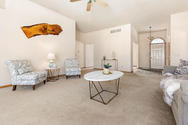 carpeted living room featuring ceiling fan