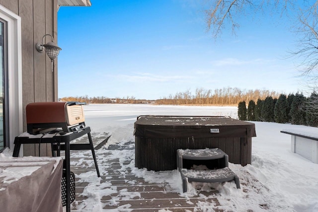 snow covered deck with a hot tub