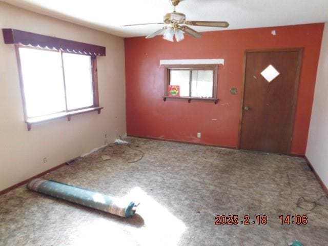 carpeted foyer with ceiling fan