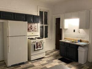 kitchen featuring white appliances and light hardwood / wood-style floors