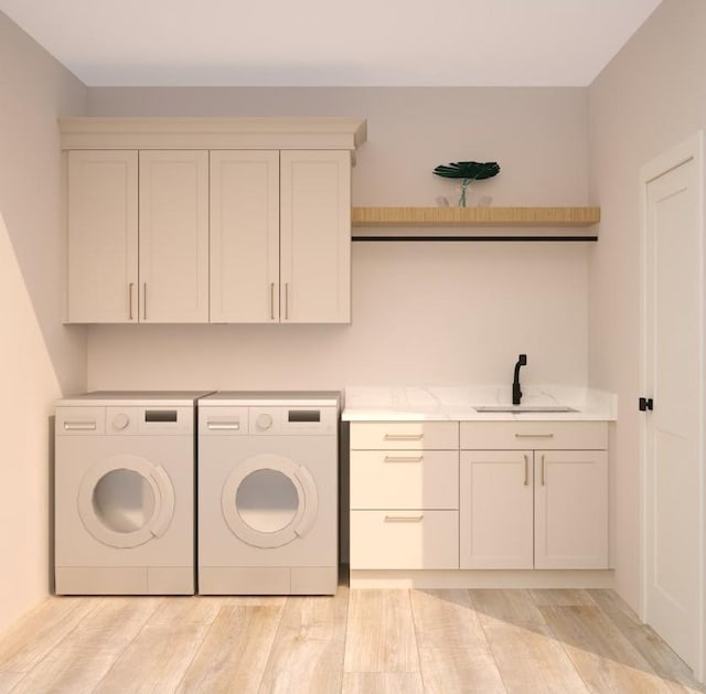 washroom with sink, cabinets, independent washer and dryer, and light hardwood / wood-style flooring