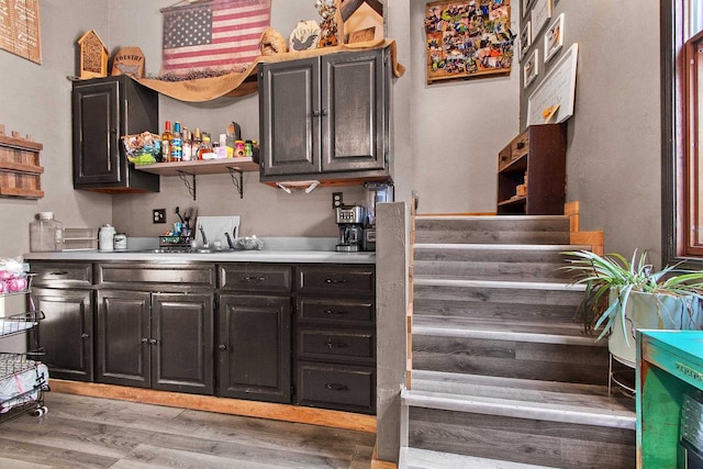 bar with light hardwood / wood-style flooring