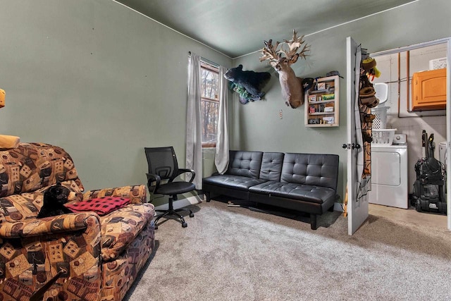 carpeted living room with washer and dryer