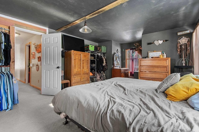 carpeted bedroom with a closet and a spacious closet