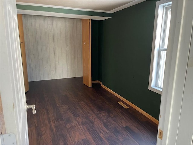 unfurnished room with dark hardwood / wood-style floors