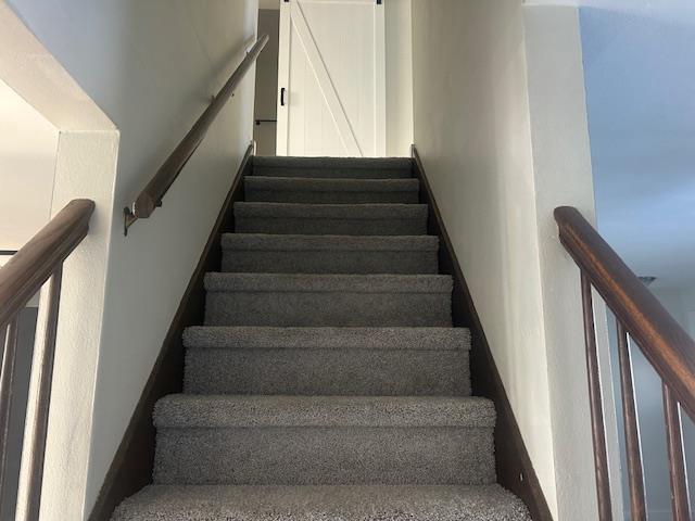 stairs featuring a barn door