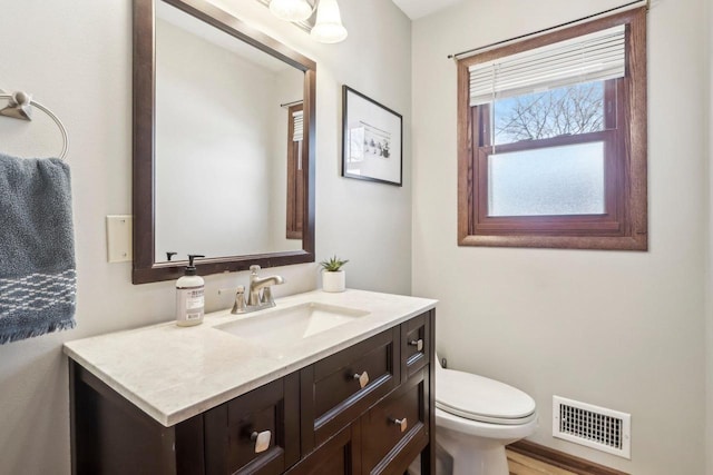 bathroom with toilet and vanity