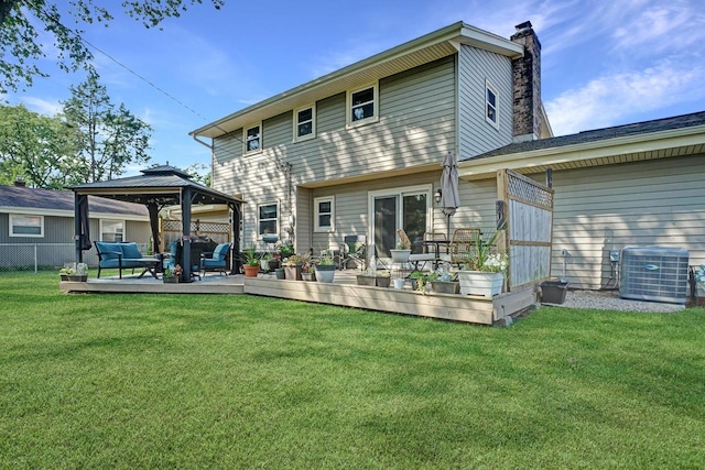 rear view of house featuring a lawn, central AC, a deck, and a gazebo