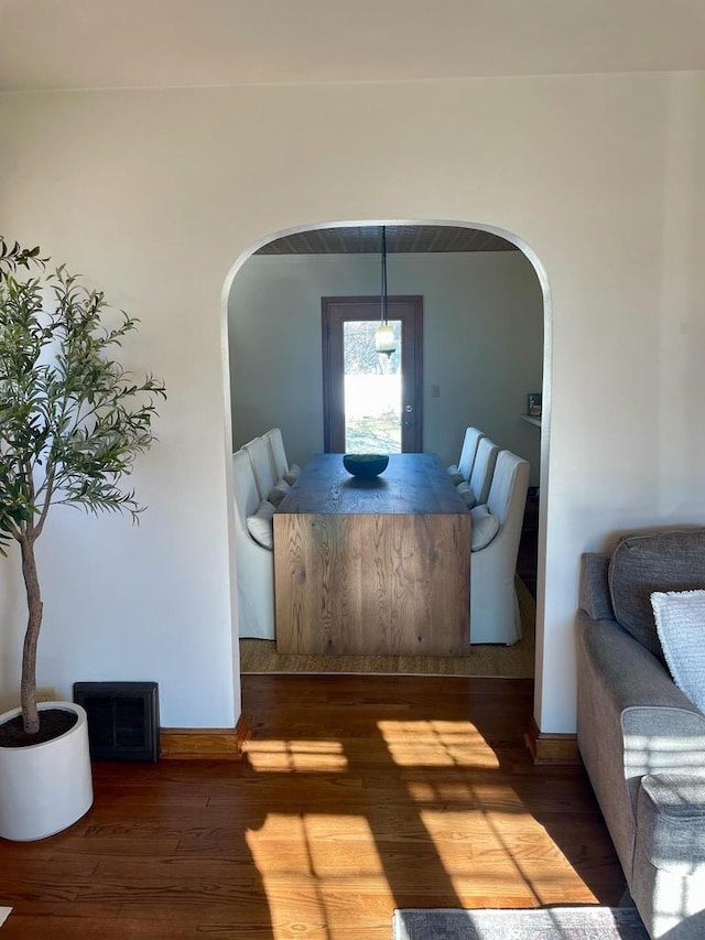 dining space with wood-type flooring