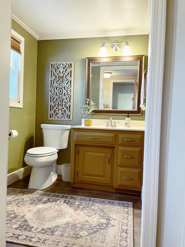 bathroom featuring tile patterned floors, vanity, toilet, and ornamental molding