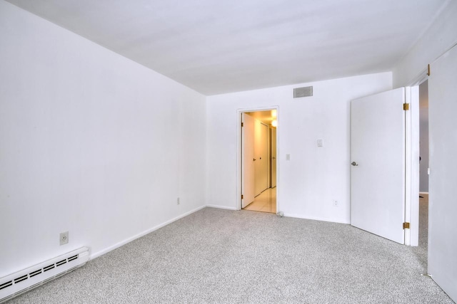 empty room with a baseboard radiator and light colored carpet