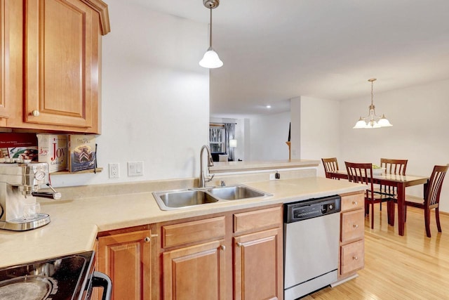 kitchen with a sink, light countertops, stainless steel dishwasher, and hanging light fixtures