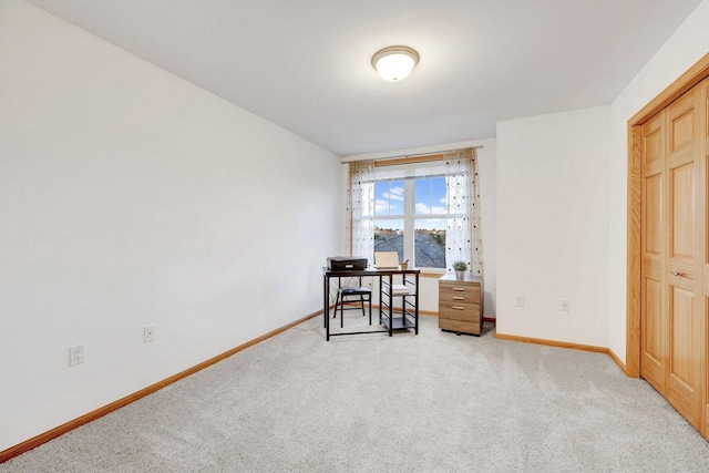 home office featuring light colored carpet and baseboards