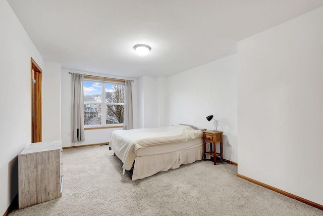 carpeted bedroom with baseboards