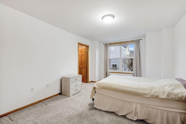 carpeted bedroom featuring baseboards