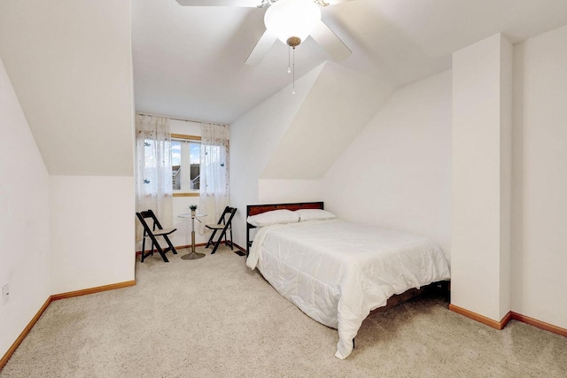 carpeted bedroom with a ceiling fan, lofted ceiling, and baseboards