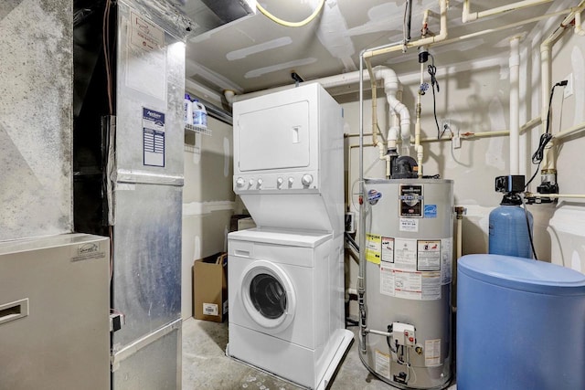 laundry area with stacked washer / drying machine, laundry area, water heater, and heating unit