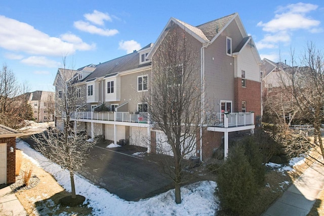 view of snowy exterior with a balcony